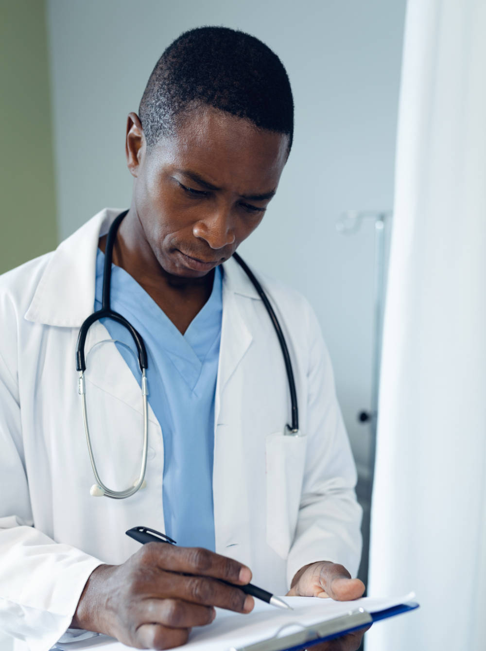 Dr Nyiko E Vukeya reviewing patient notes